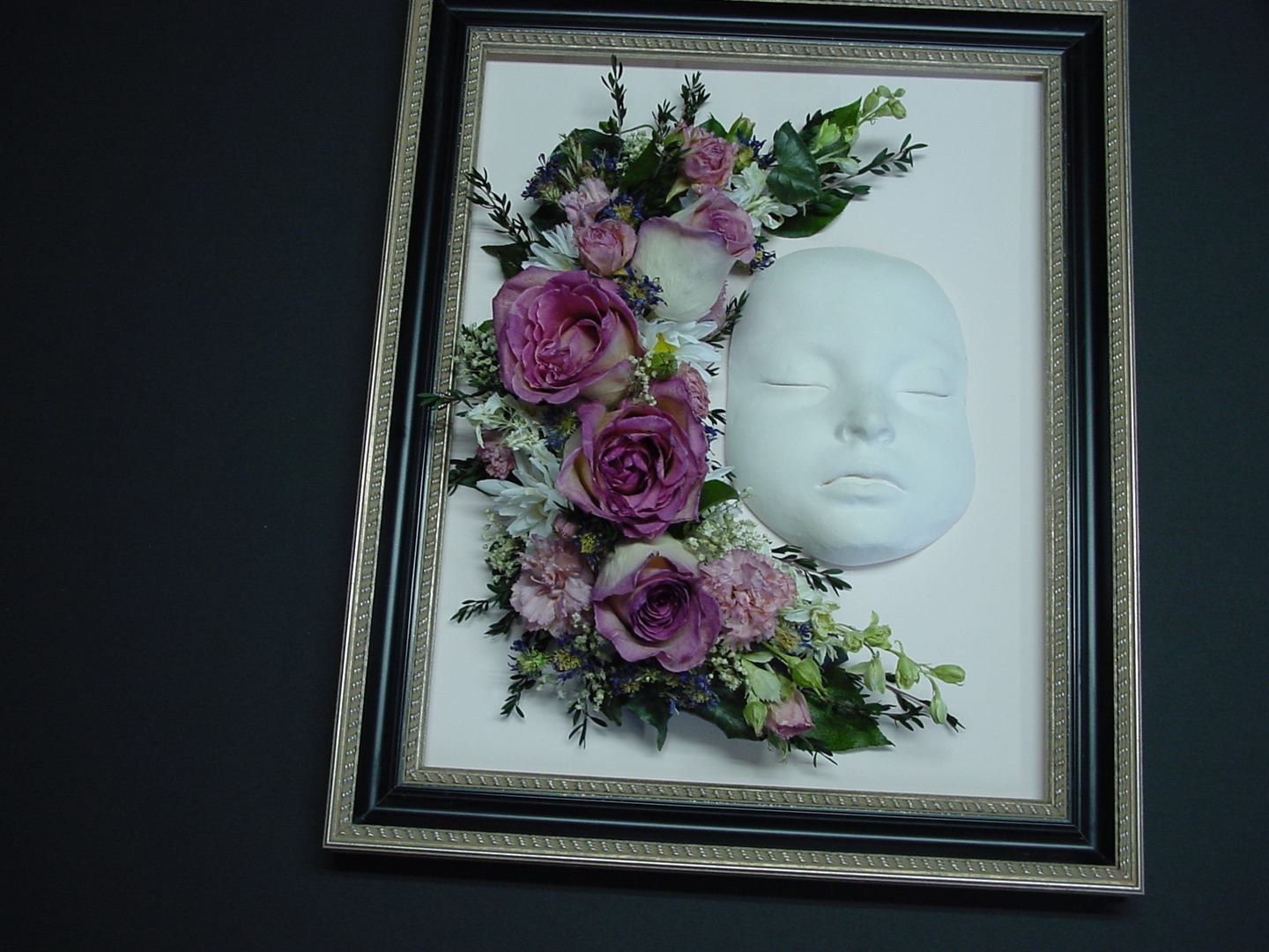 A Wine Color Flower Pattern With a White Mask in a Frame